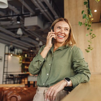 Woman smiling while talking on phone