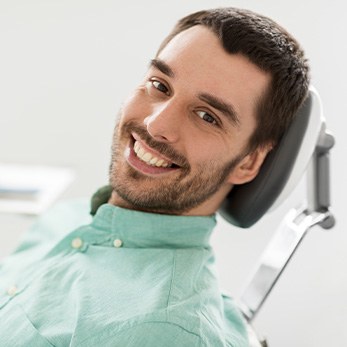 Patient smiling while sitting in treatment chair