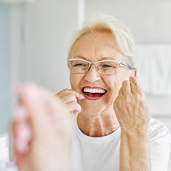 Woman smiling while looking at dentist in treatment chair