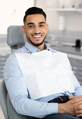 Patient smiling while sitting in treatment chair