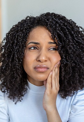 Woman experiencing toothache at home