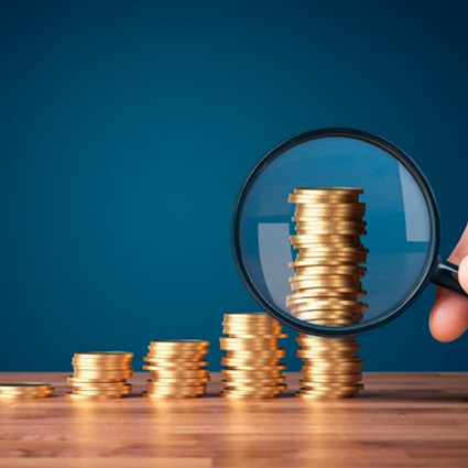 Stacks of coins examined with magnifying glass
