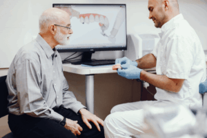 a patient speaking with their dentist about dental implants