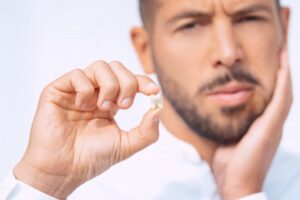 Man holding his knocked out tooth